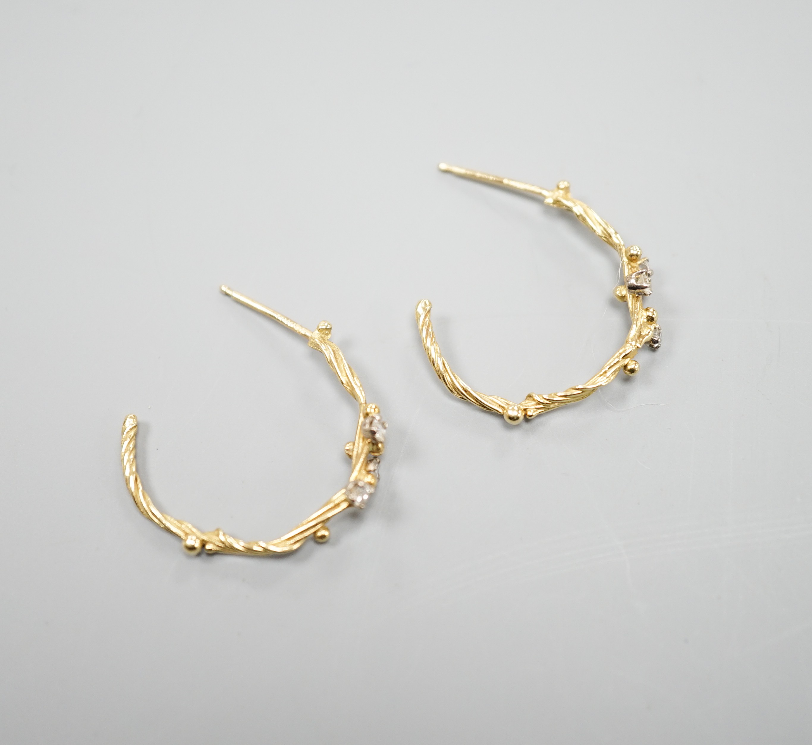 A pair of 18ct gold and three stone diamond set rustic hoop earrings, no butterflies, 25mm, gross weight 3.5 grams.